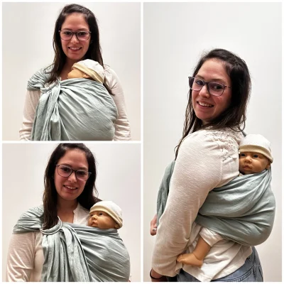Frau trägt ein Baby mit einem hellgrünen Ringsling auf der linken Schulter